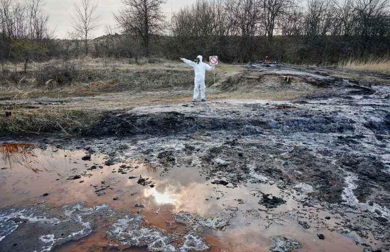 Scientist exploring territory, emission area, polluted water, man in protective suit